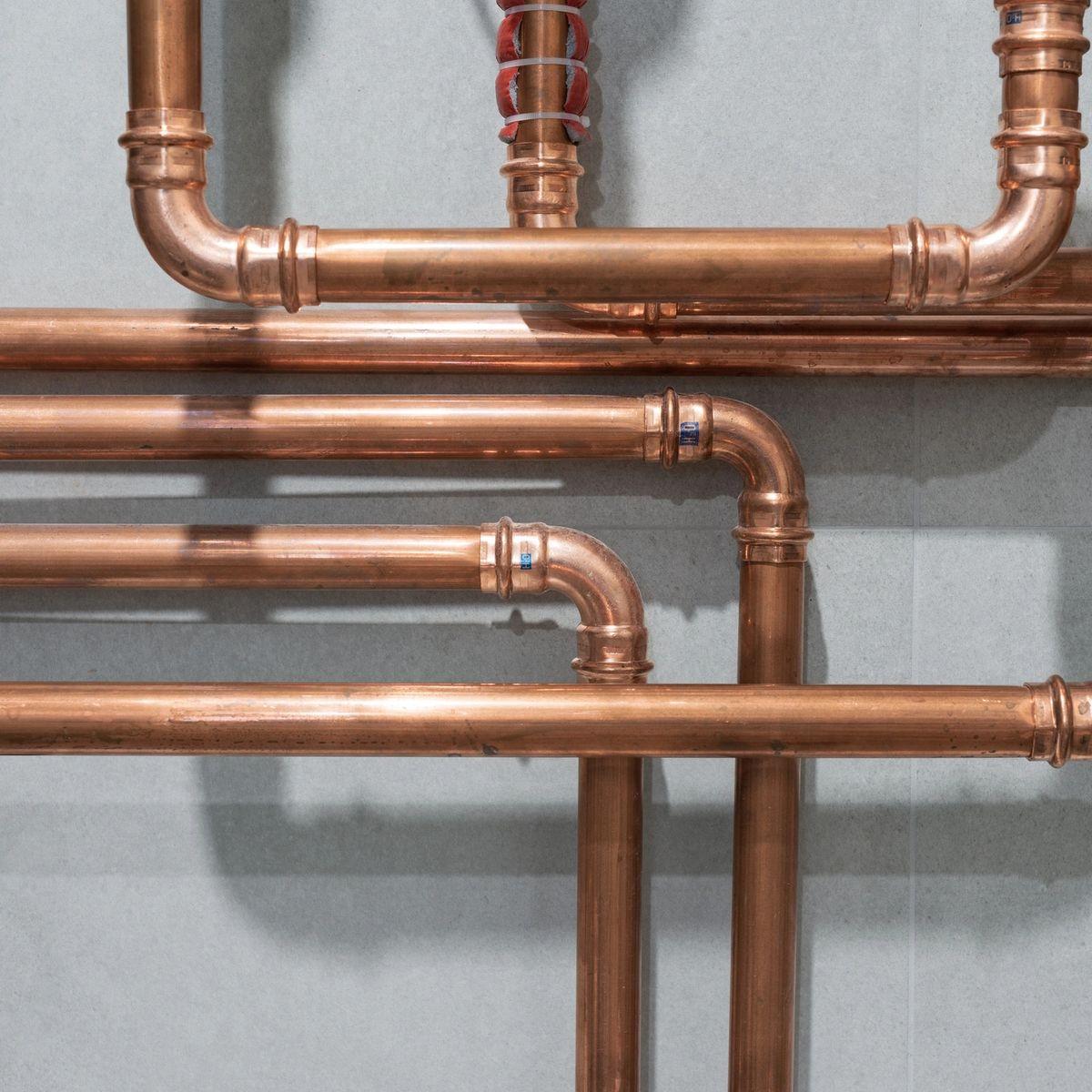Precision copper plumbing lines installed with professional fittings
